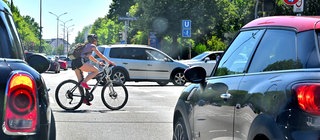 Ein Radfahrer auf einer Kreuzung zwischen Autos.