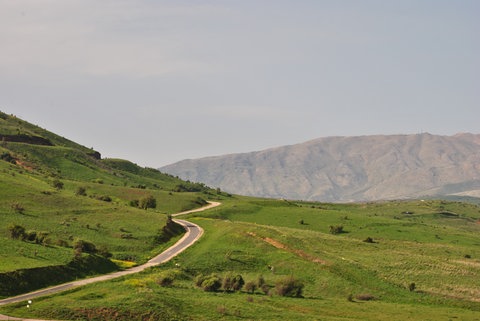 Eine Straße schlängelt sich durch eine hügelige Landschaft