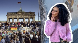 Reporterin Tessniem vor dem Foto vom Mauerfall am Brandenburger Tor