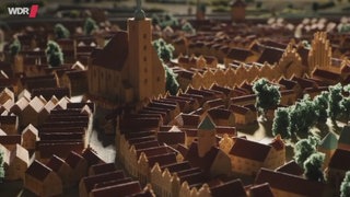 Eine Stadt modelliert aus Holzfiguren.